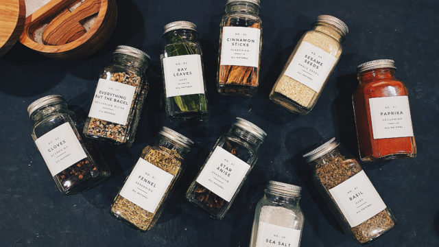 Picture of various spice jars laid flat on a chopping board.