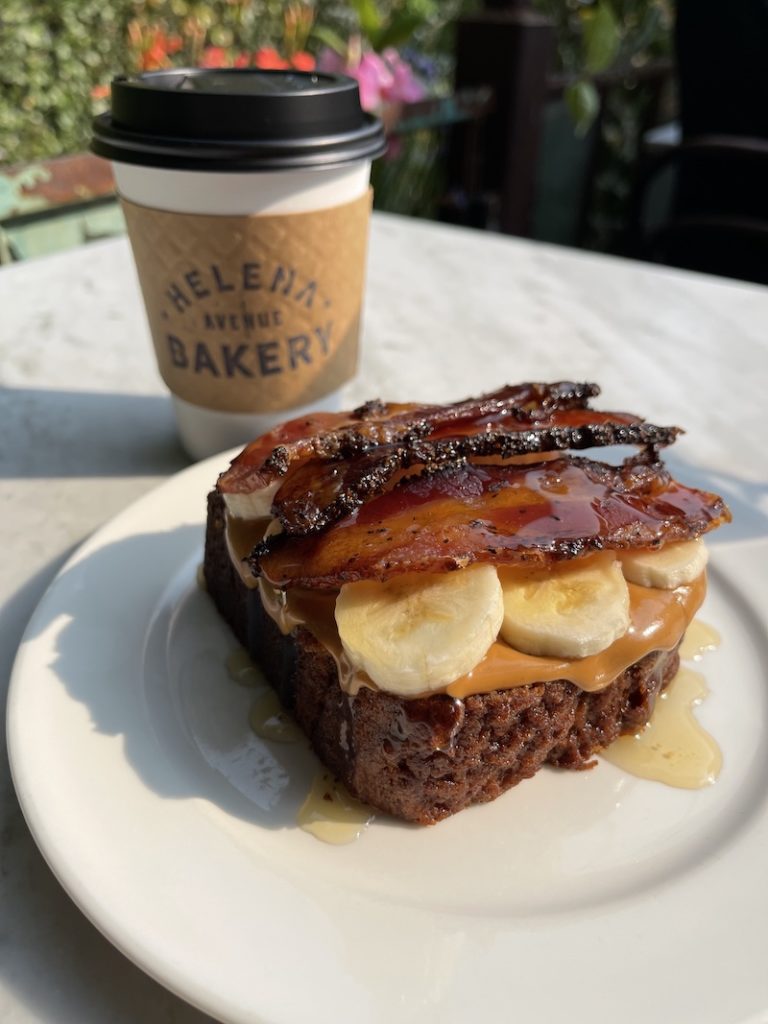 delicious bacon topped savory sweet sandwich and a coffee
