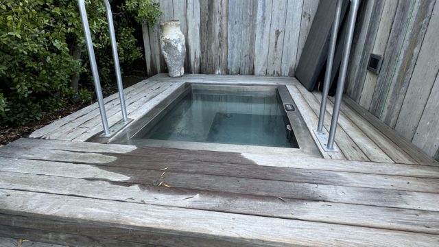cold plunge pool sunken into a wooden platform