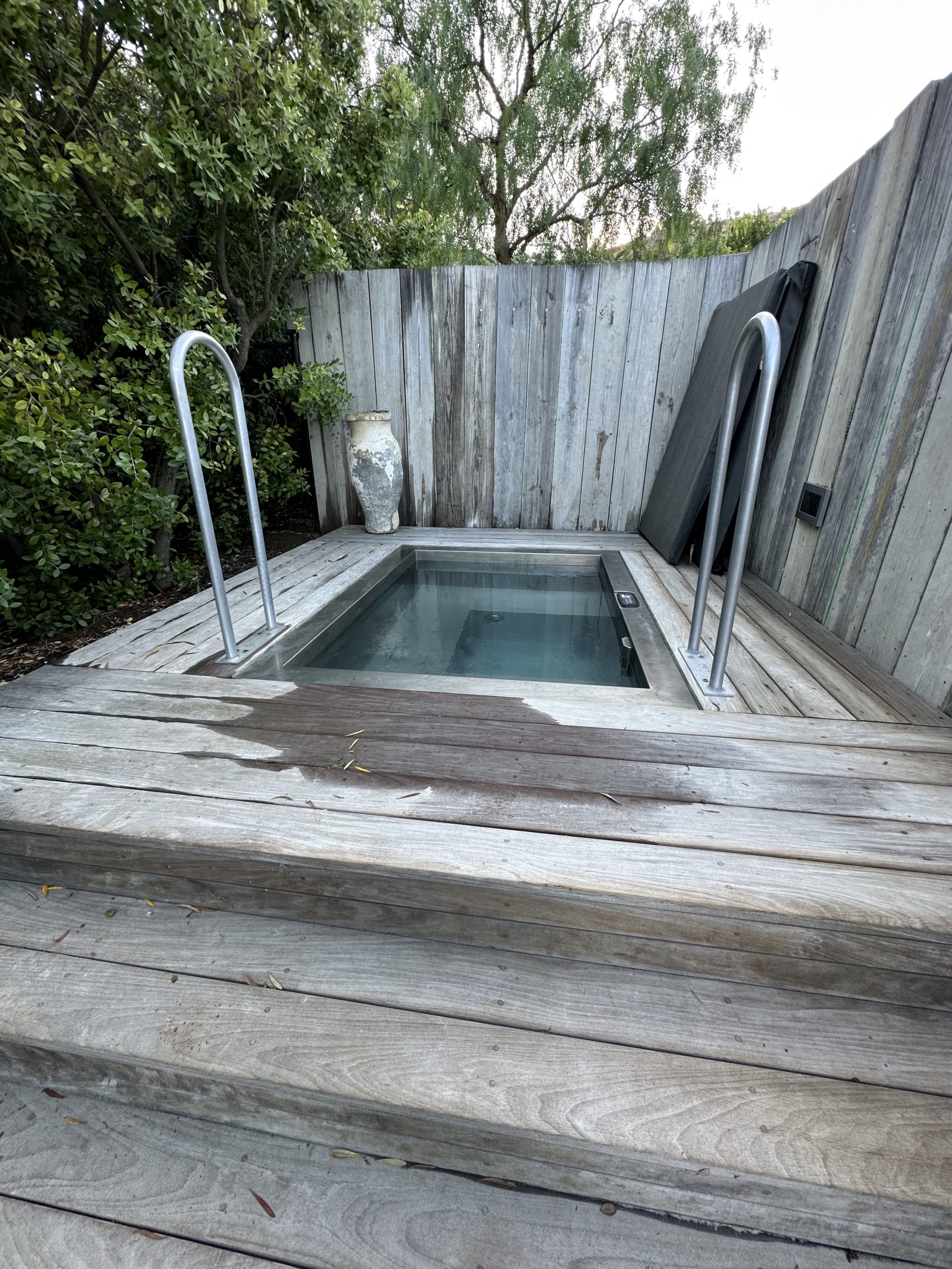 cold plunge pool sunken into a wooden platform